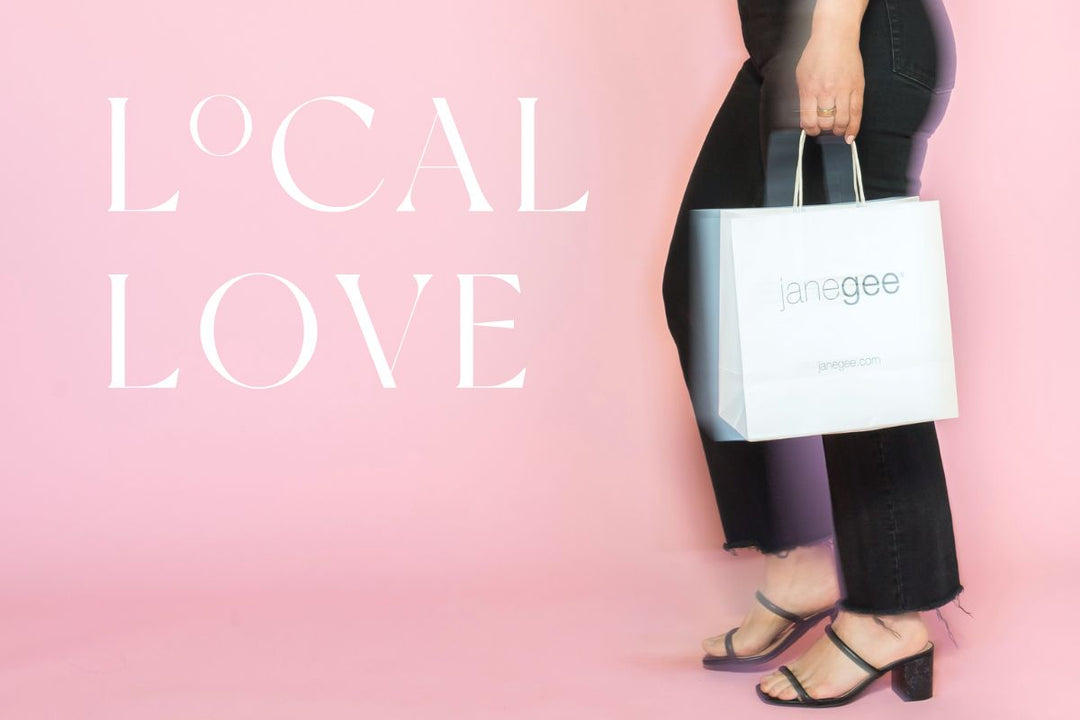 Person holding a janegee shopping bag against a pink background with “Local Love” text displayed.