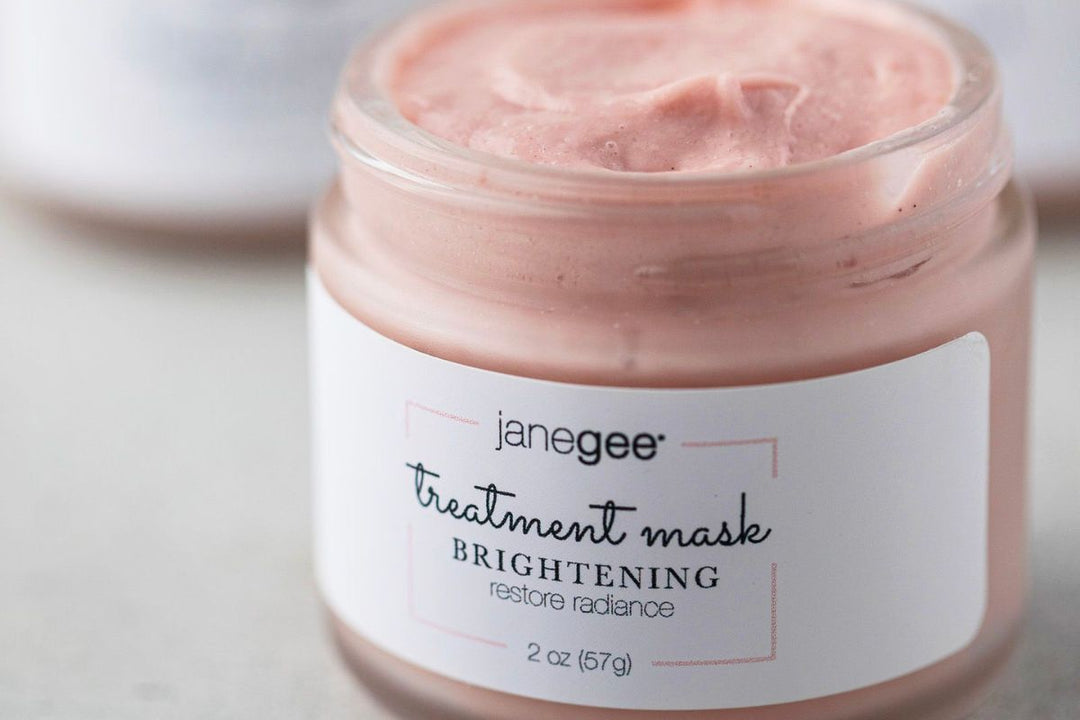 Close-up of an open jar of janegee brightening treatment mask showing the creamy pink texture.