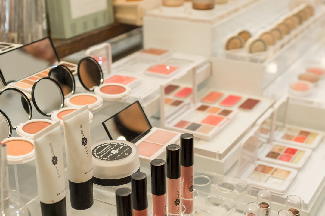 Clean beauty makeup display featuring non-toxic foundations, blushes, eyeshadows, and lip products at janegee.