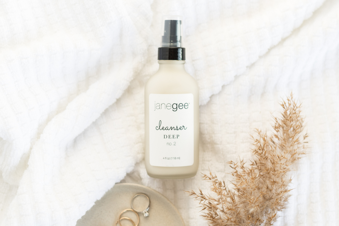 janegee deep cleanser bottle on a soft white textured background with neutral styling and delicate accents