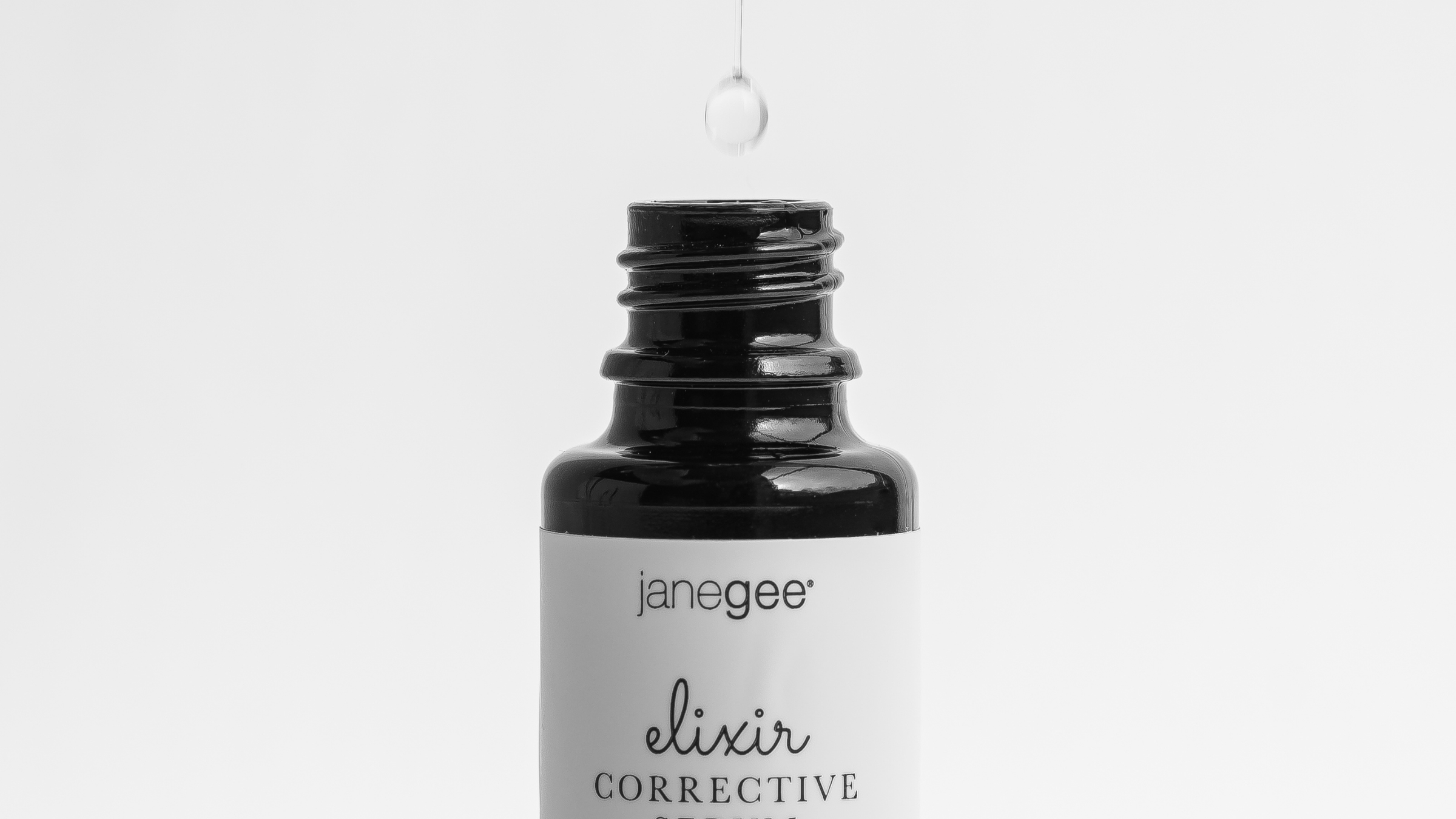 janegee Elixir Corrective Serum with serum drop above bottle