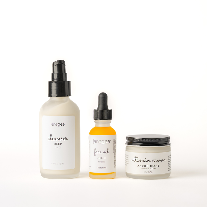 Three janegee skincare essentials for mature skin displayed on a white background, featuring Cleanser Deep No. 2, Face Oil No. 1, and Vitamin Creme Antioxidant Moisturizer.