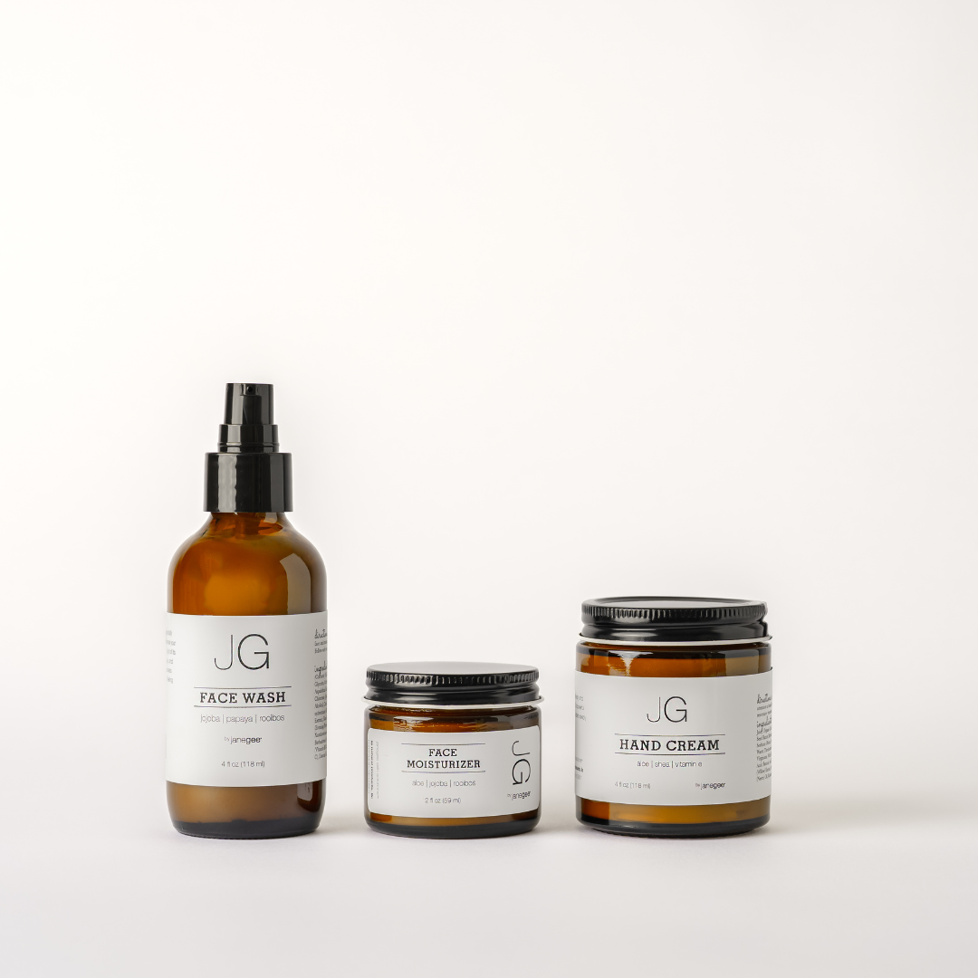 Three janegee men's skincare essentials arranged on a white background, featuring Face Wash, Face Moisturizer, and Hand Cream in amber glass packaging with clean, modern labels. 