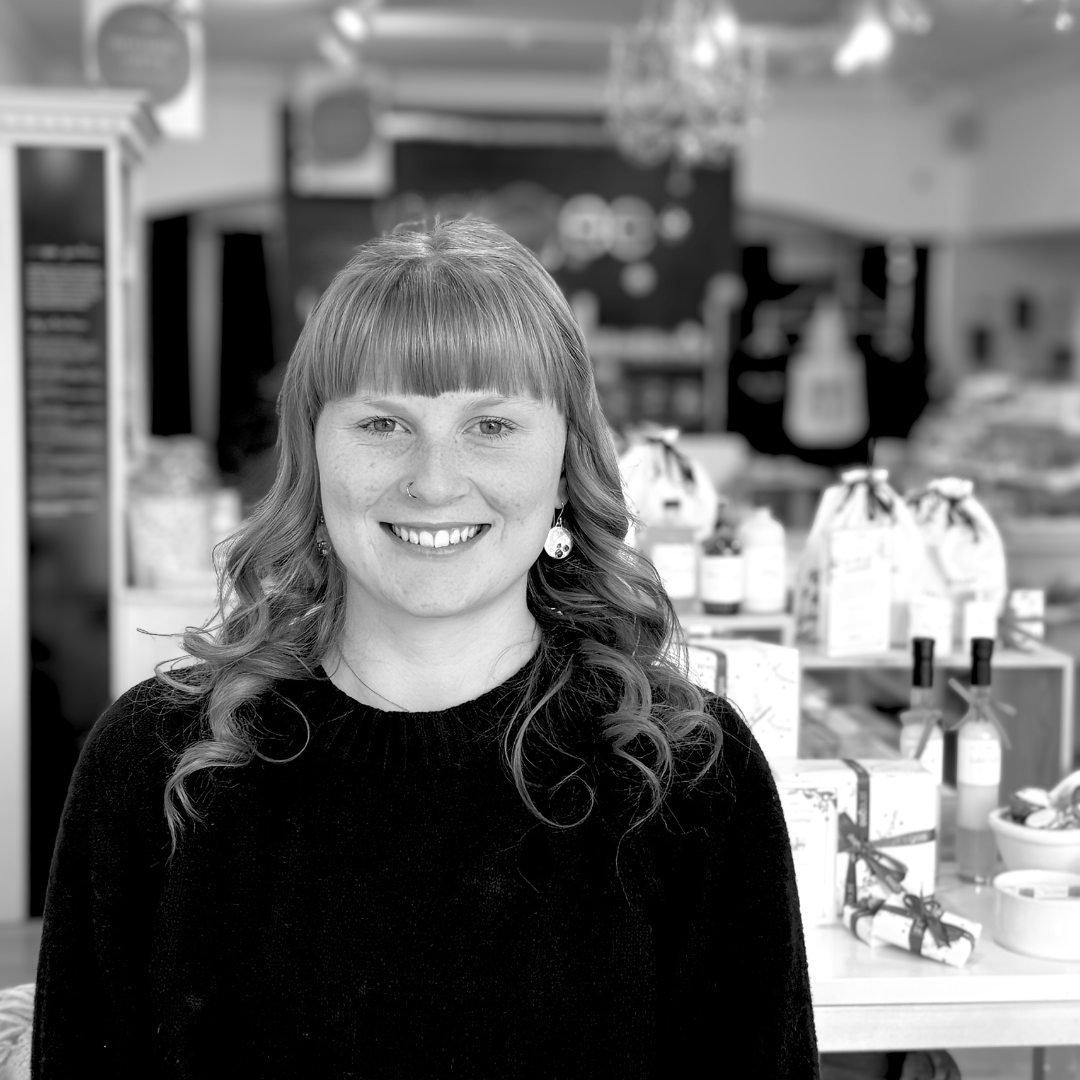 Black and white photo of a woman with long hair in a store setting