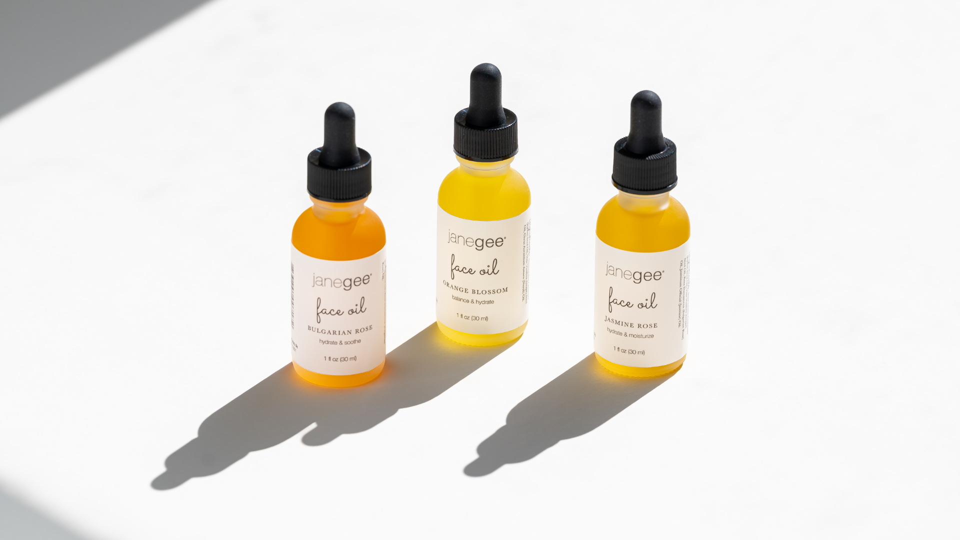 Three janegee Facial Oils on a white background with a back shadow. 