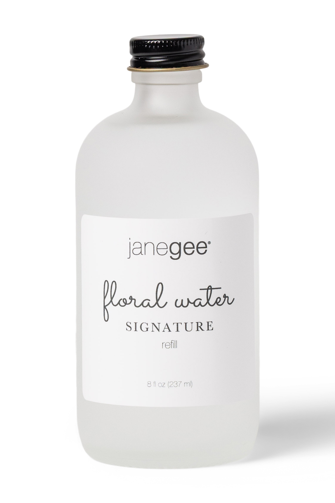 Frosted glass bottle of janegee floral water on a white background