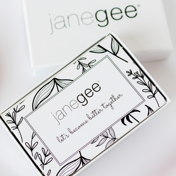 Decorative janegee gift card box with black botanical detailing and the phrase “let’s become better together” displayed on a white background.
