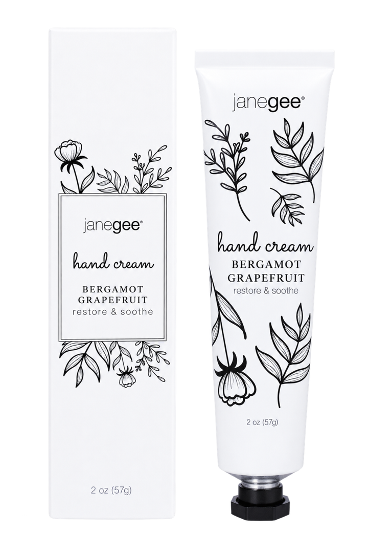 janegee hand cream in Bergamot Grapefruit scent, shown as a white squeeze tube with black botanical illustrations next to its matching white cardboard packaging box.