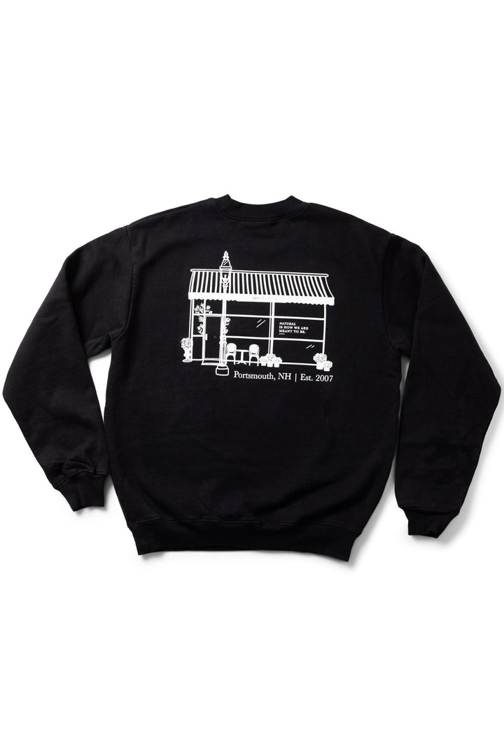 Black sweatshirt with white store front graphic design on a white background