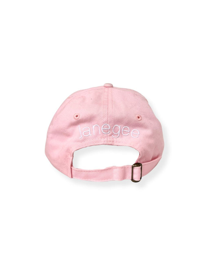 Back view of the pink janegee Everyday Botanical Cap with white embroidered janegee logo and adjustable brass buckle strap on a white background.